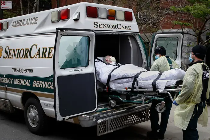 A patient is loaded into an ambulance by emergency medical workers outside Cobble Hill Health Center in the Brooklyn borough of New York.